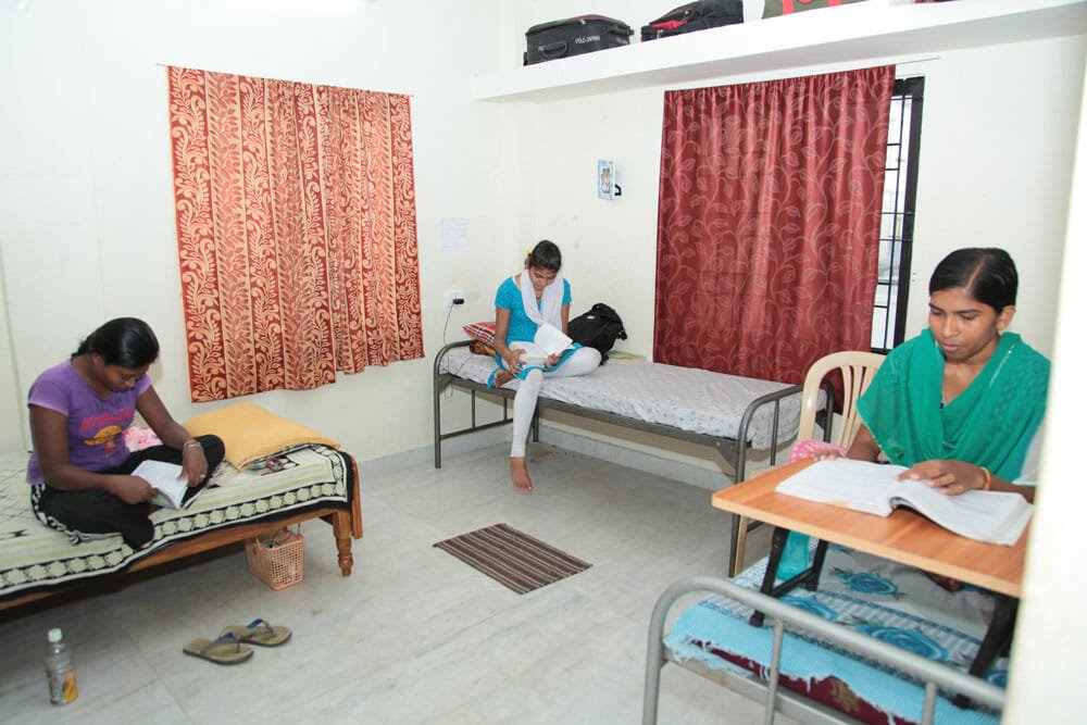 Girls hostel residents studying together in the evening